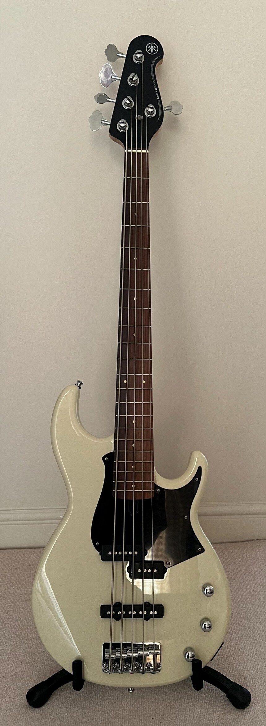 In‑room photo of Lottie’s Yamaha BB235 bass guitar on a stand.